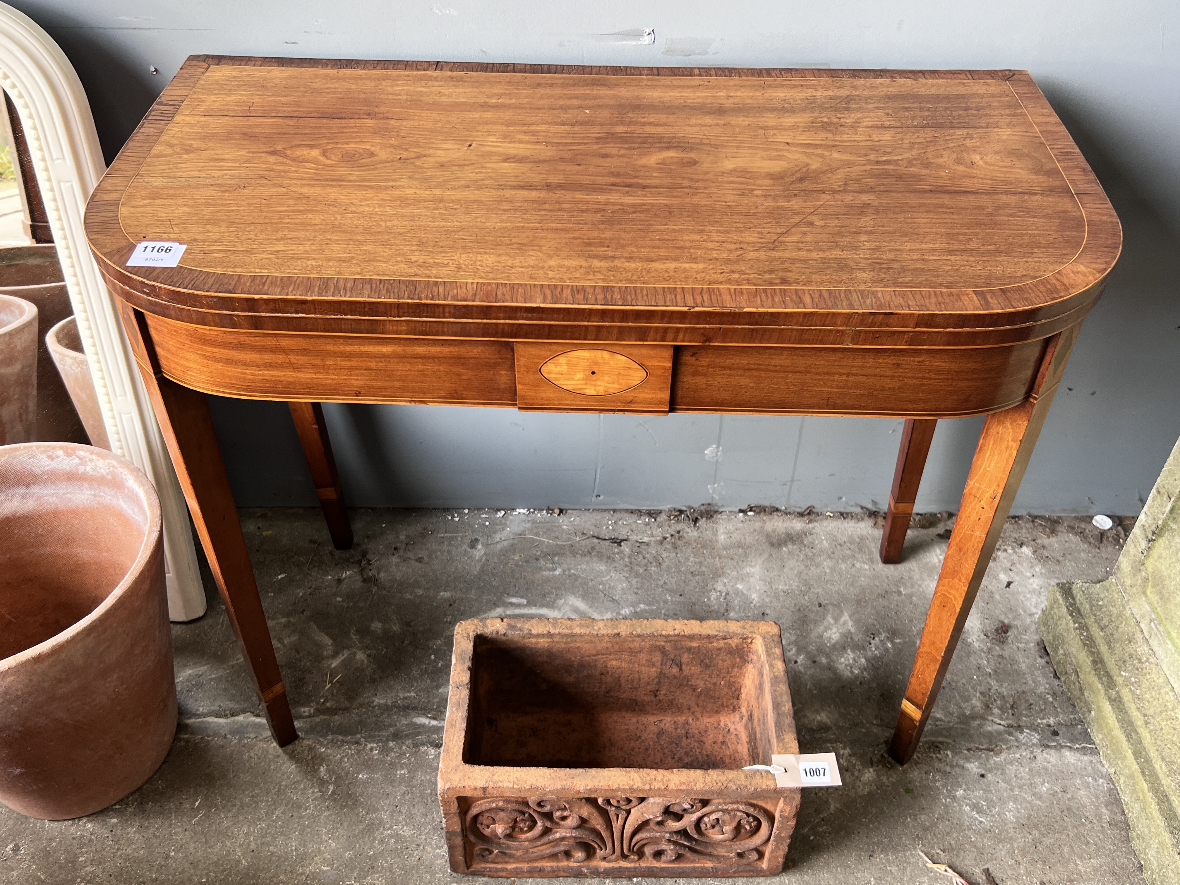 A George III rosewood banded inlaid mahogany tea table, width 92cm, depth 45cm, height 74cm (one leg in need of restoration)